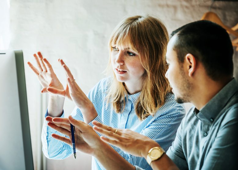 Colleagues Problem Solving At Computer Together