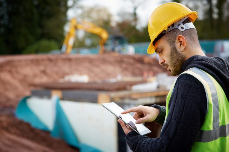 Supervisor with tablet PC at construction site