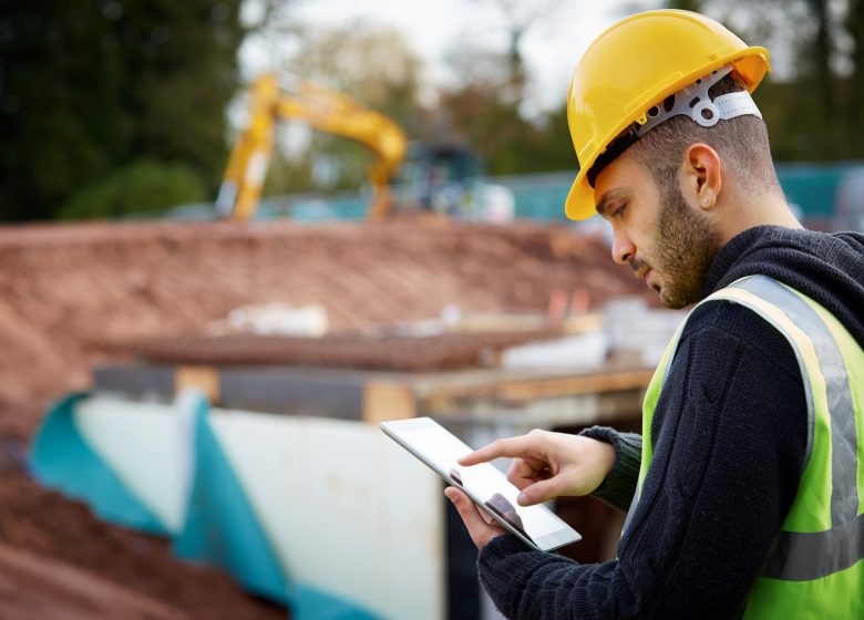 Supervisor with tablet PC at construction site