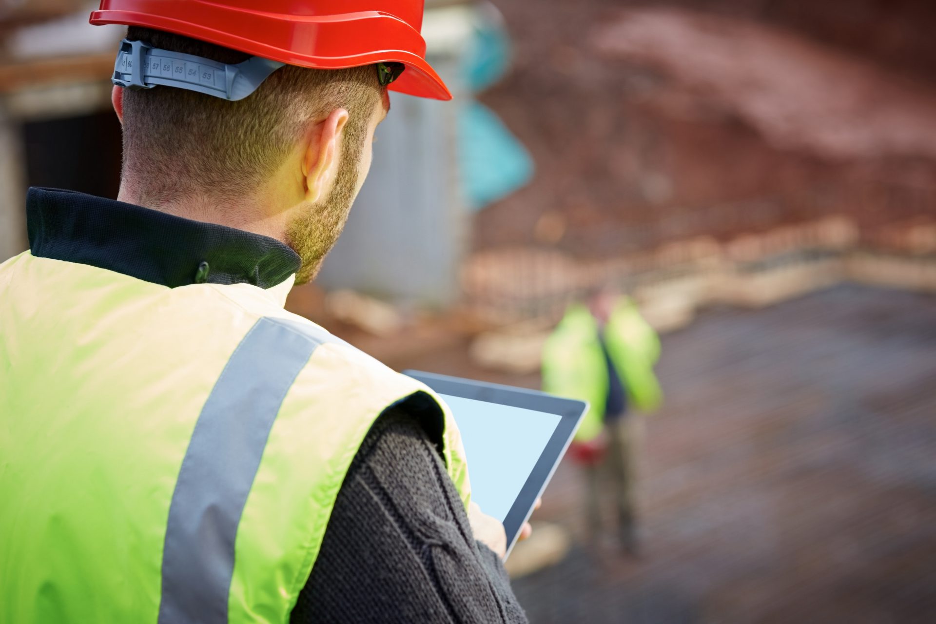 Construction worker working with digital tablet on site