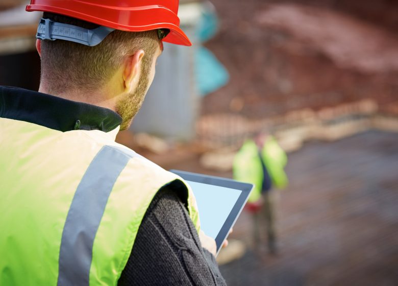 Construction worker working with digital tablet on site